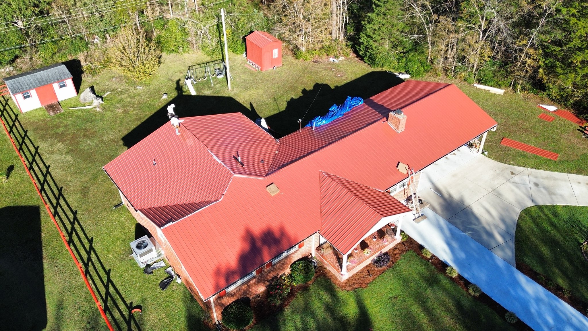 New Red Corrugated Metal Roof and New Batten Siding replaced from wind and hail damage in North Carolina